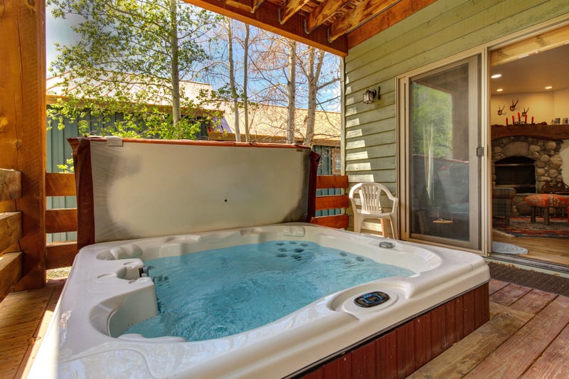 Step from the family room into your private hot tub, perfect for unwinding beneath the trees after a day outdoors.