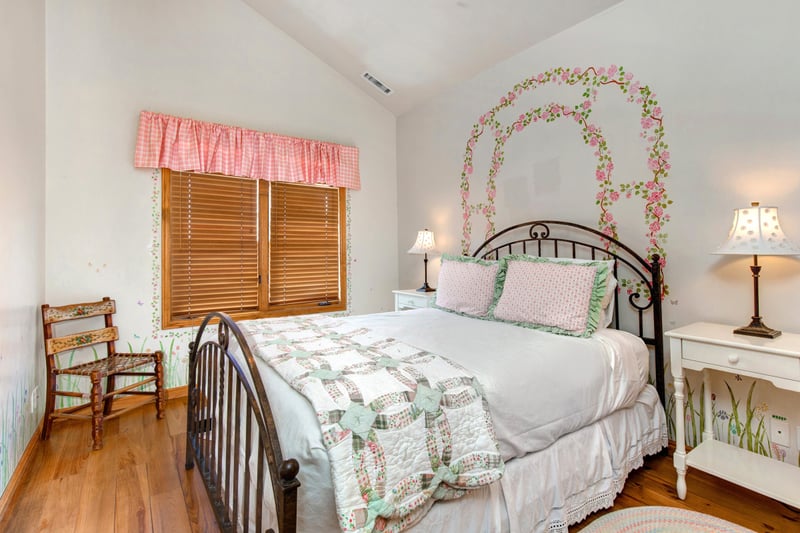 Guest Bedroom includes a Queen bed, vaulted ceiling, and shared access to a full hall bath.