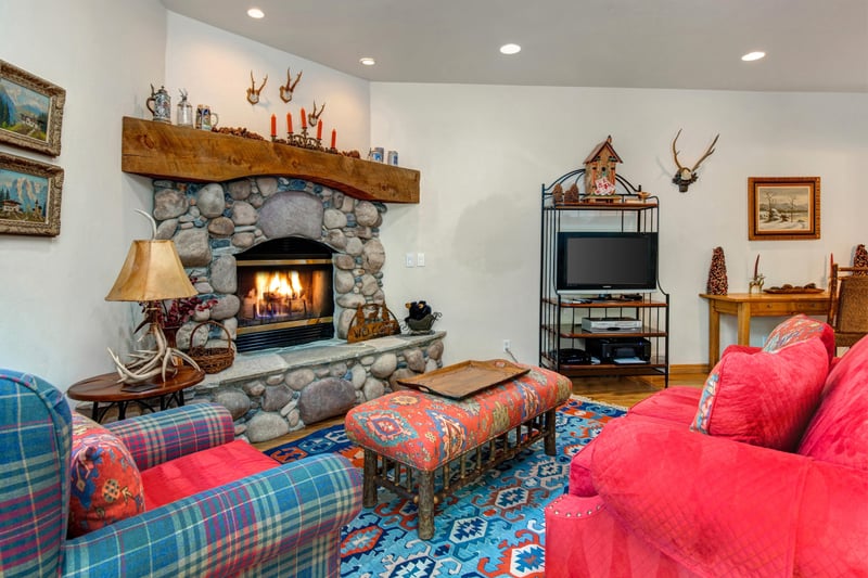 Family room with a large sectional, fireplace, and mounted TV is perfect for game nights or movie marathons.