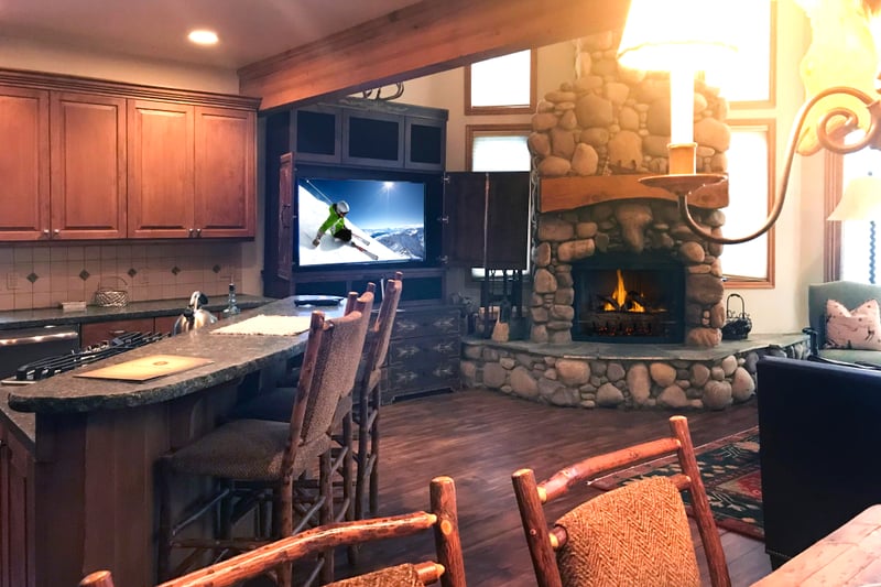 Open-concept great room with wood floors, vaulted ceilings, and oversized windows for all-day light.