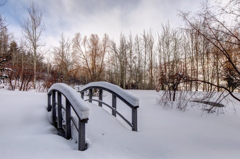 Snowy paths and a private footbridge set the tone for winter wonderland strolls.
