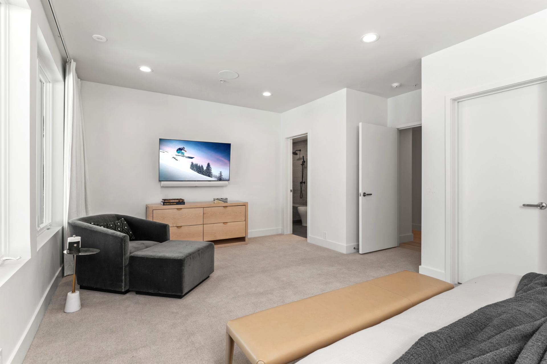 Second angle of Bedroom 6 reveals built-in shelving and ensuite access.