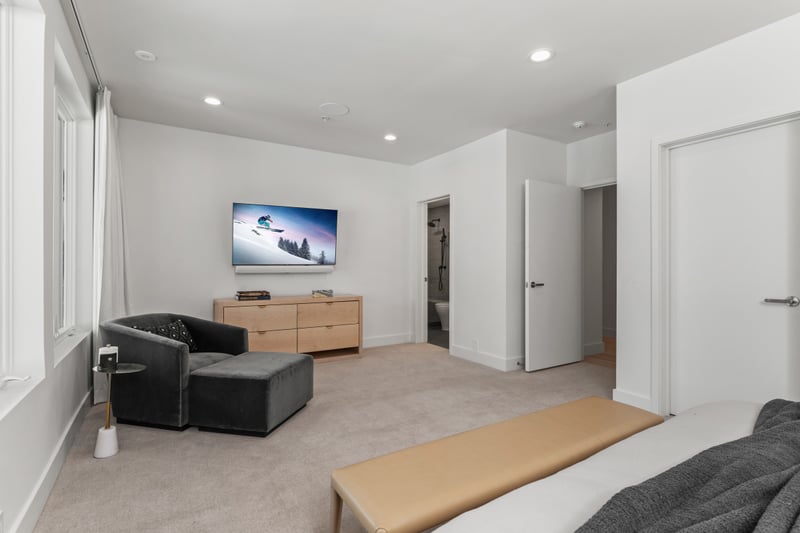 Second angle of Bedroom 6 reveals built-in shelving and ensuite access.