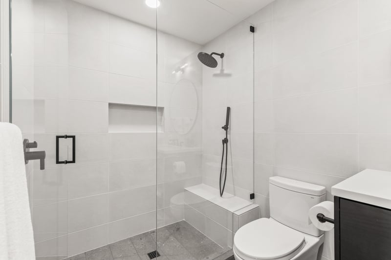 Ensuite bath with walk-in shower and tile wall.