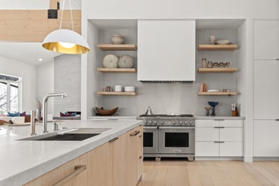Cook with ease in your gourmet kitchen with custom cabinetry, a large island, and designer lighting.