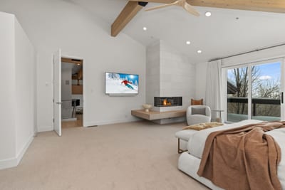 Wake up to treetop views in your luxurious primary suite with King bed and built-in TV.