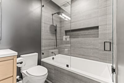 Attached to Bedroom 2, this bathroom features a soaking tub and tile surround.