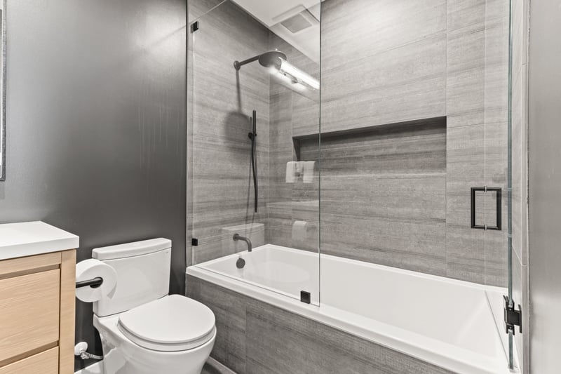 This bathroom features a soaking tub and tile surround.