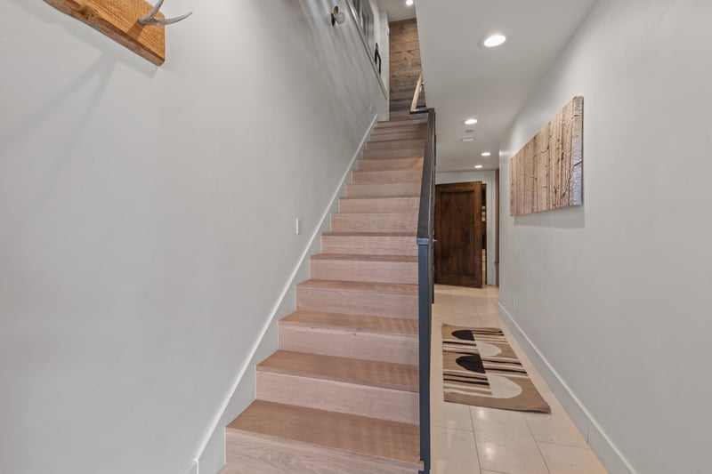 Stylish stairwells connect three spacious levels, offering privacy and flow throughout. PEA-1009