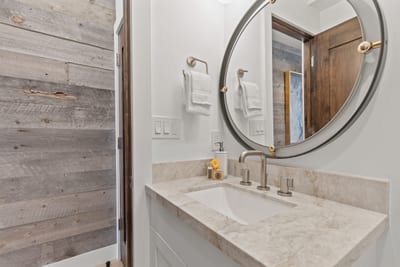 Conveniently located on the main level, this half bath features a stone vanity and designer finishes.
