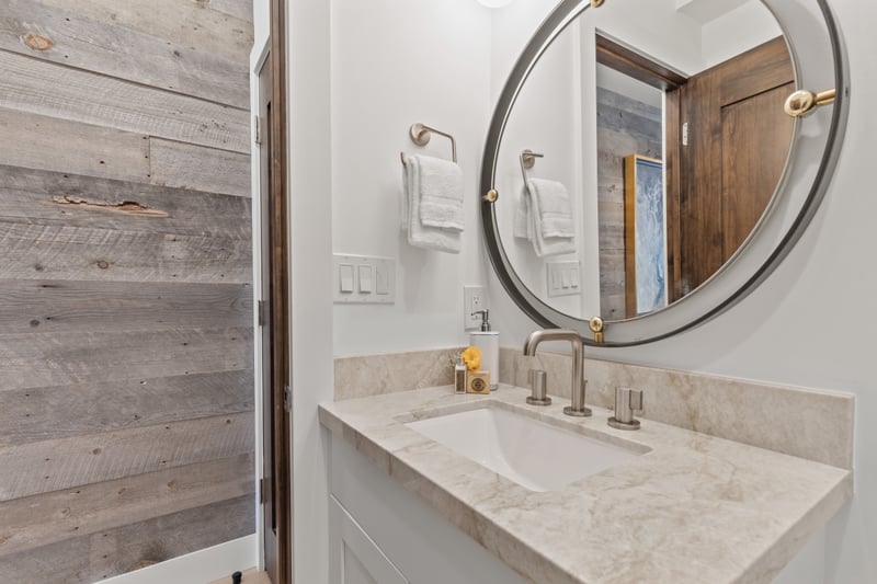Conveniently located on the main level, this half bath features a stone vanity and designer finishes.