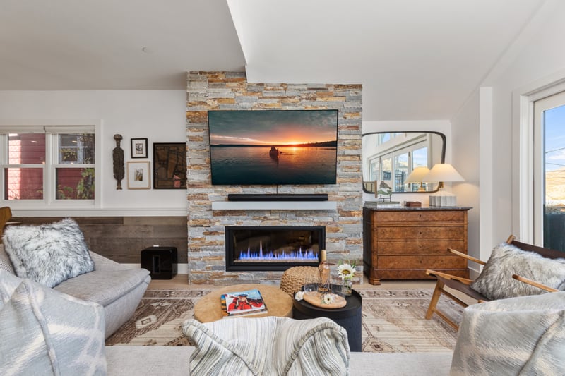 Natural light fills this cozy lounge space with modern furnishings and an inviting fireplace. PEA-1009