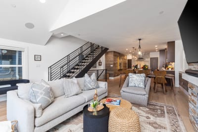 A third living view highlights spacious seating, stylish accents, and open layout across levels. PEA-1009