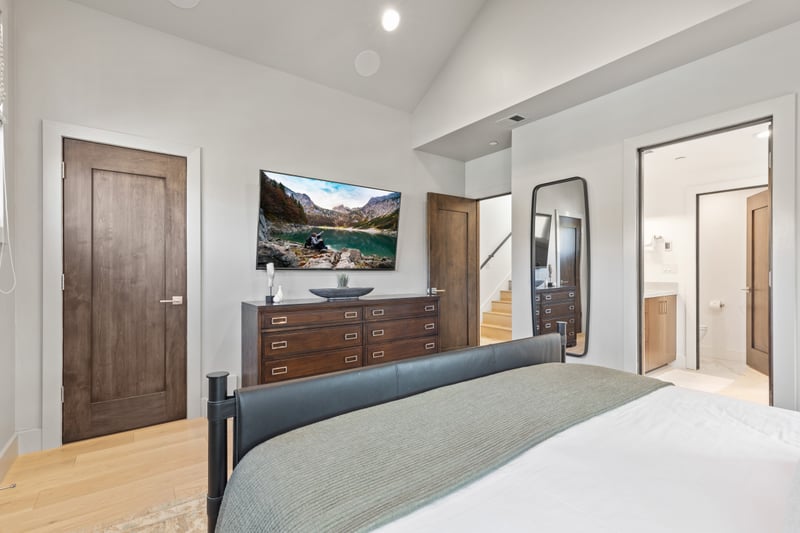 Another view of the main King suite reveals mountain views, wall-mounted TV, and elegant simplicity. PEA-1009