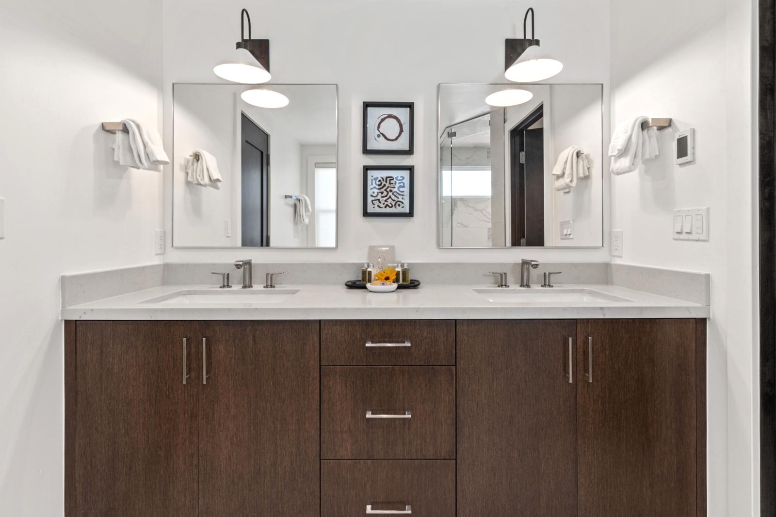 Dual vanities and custom cabinetry provide ample space for two in your ensuite bath.