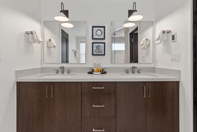 Dual vanities and custom cabinetry provide ample space for two in your ensuite bath. PEA-1009