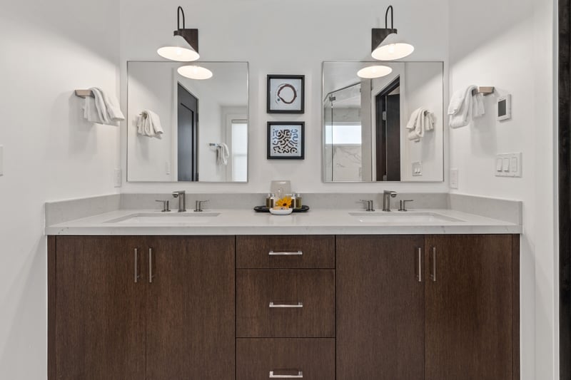 Dual vanities and custom cabinetry provide ample space for two in your ensuite bath. PEA-1009