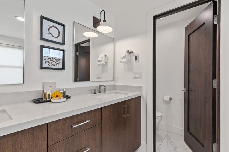 Alternate angle showing custom lighting, mirror accents, and elegant finishes. PEA-1009