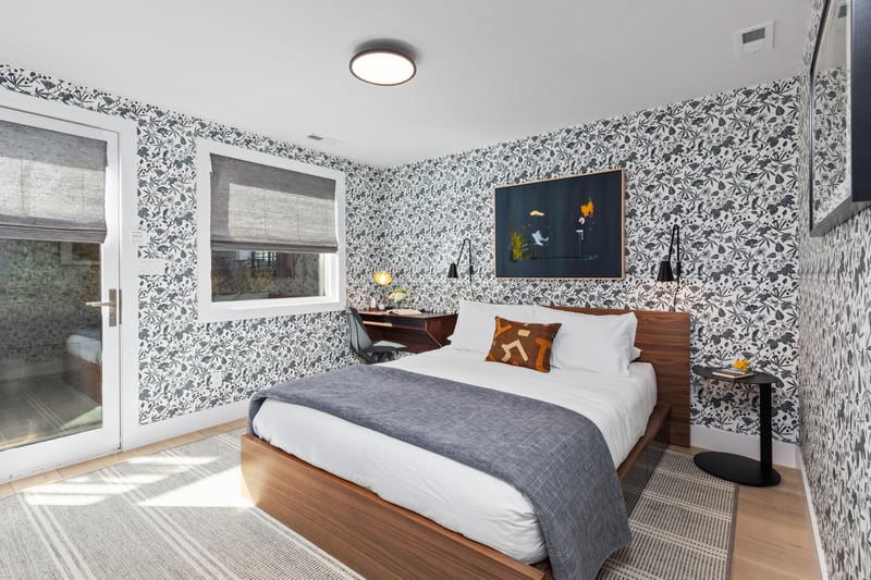 Guest room includes a King bed, mountain views, and bold accent wall for added style. PEA-1009
