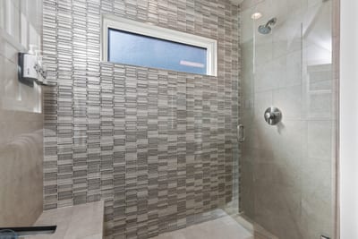 A custom tile walk-in shower adds spa-like touches to the second bath.