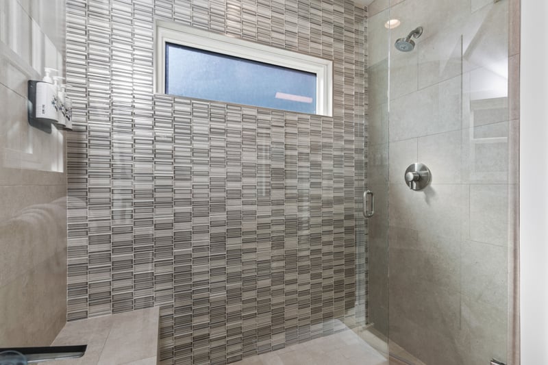 A custom tile walk-in shower adds spa-like touches to the second bath.