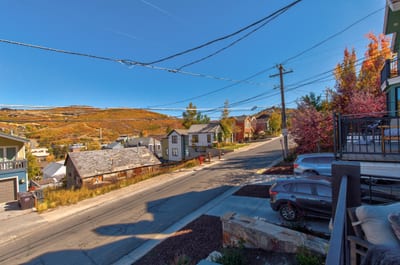 Front-facing views capture the charm of the surrounding neighborhood and nearby hills. PEA-1009