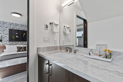 Modern double sinks and a clean aesthetic define this second ensuite bathroom.
