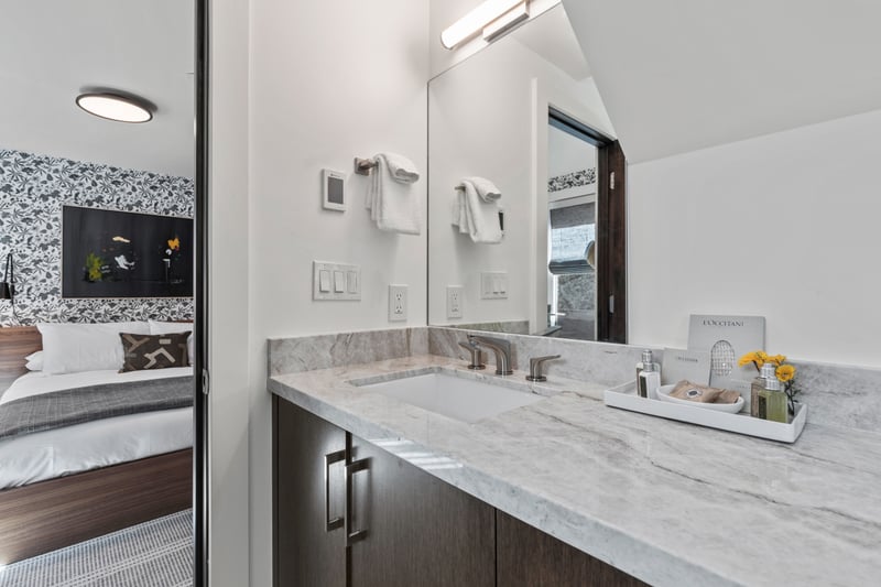 Modern double sinks and a clean aesthetic define this second ensuite bathroom.