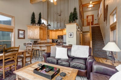 Relax by the fire in this warm and welcoming living space, where the vaulted ceiling opens up to the kitchen and dining area.