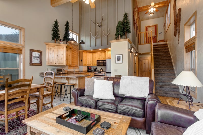 Relax by the fire in this warm and welcoming living space, where the vaulted ceiling opens up to the kitchen and dining area.
