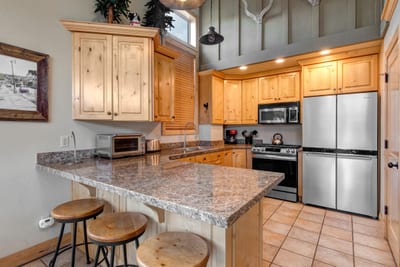 Cook with ease in your fully equipped kitchen featuring granite countertops, stainless appliances, and bar seating for casual bites.