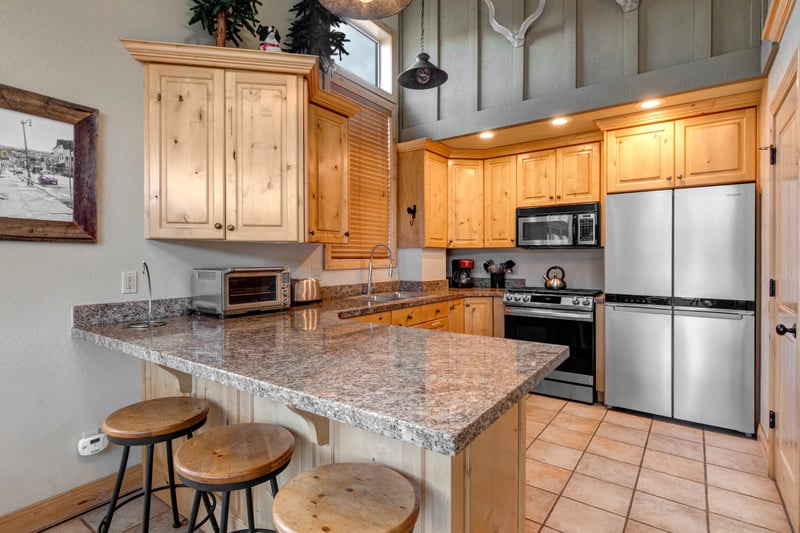 Cook with ease in your fully equipped kitchen featuring granite countertops, stainless appliances, and bar seating for casual bites.