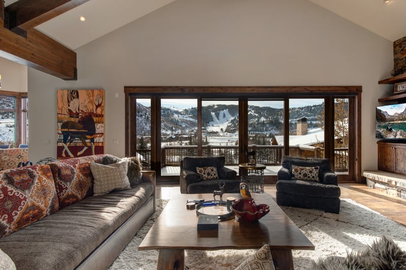 Slide open the glass doors and gather in the main living area, where indoor comfort meets fresh mountain air.