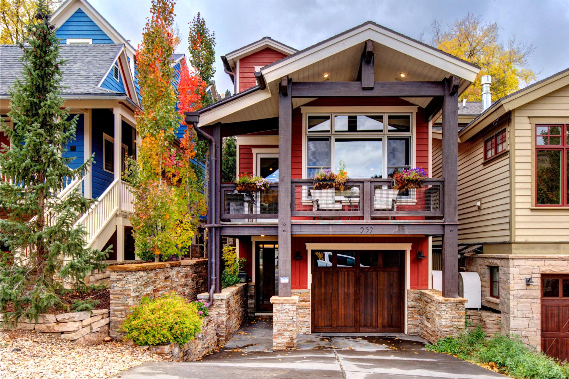 Front steps lead to a covered entry framed by rich wood and stone.