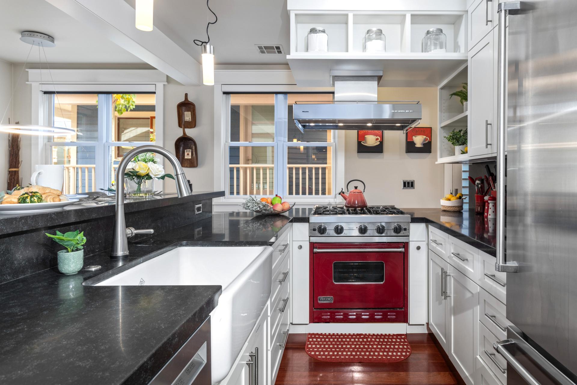 Cook with ease in your gourmet kitchen featuring high-end appliances, deep farmhouse sink, and bar seating.