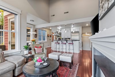 An alternate living view shows leather seating, Smart TV, and fireplace, ideal for winding down.