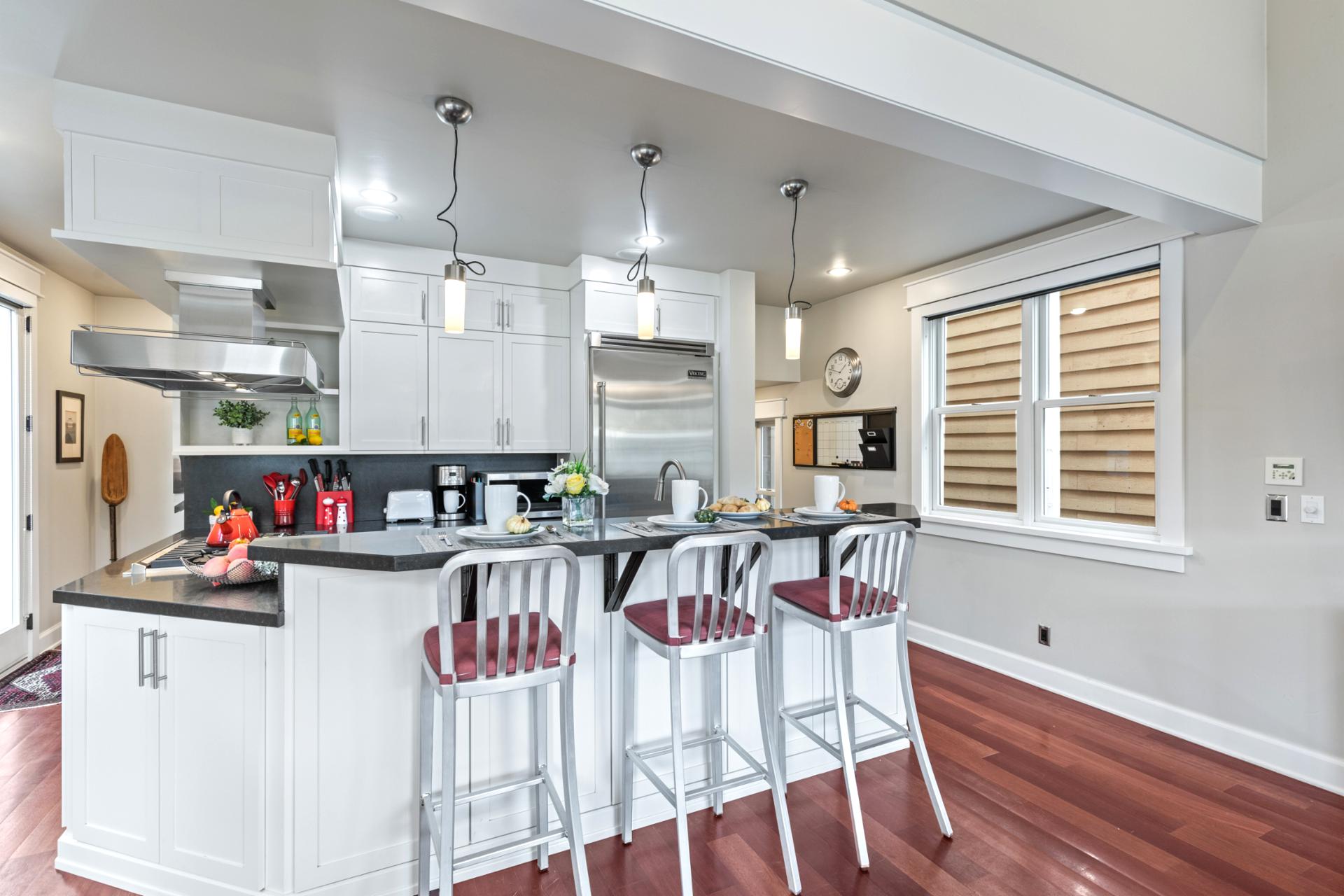 This second kitchen view highlights ample counter space and breakfast bar seating for four.