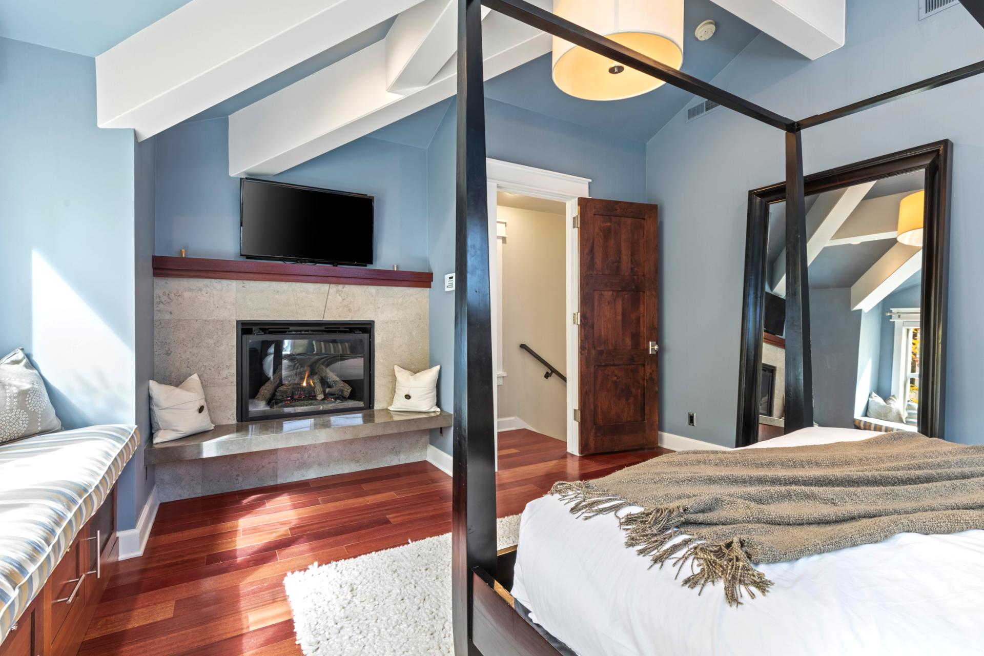 King suite with cozy corner seating, natural light, and a private ensuite spa bath.