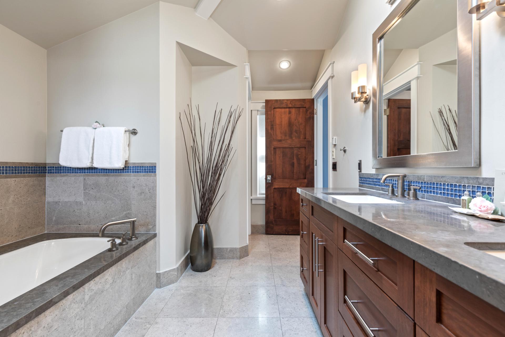 Unwind in the soaking tub or steam in the glass walk-in shower of your primary ensuite.