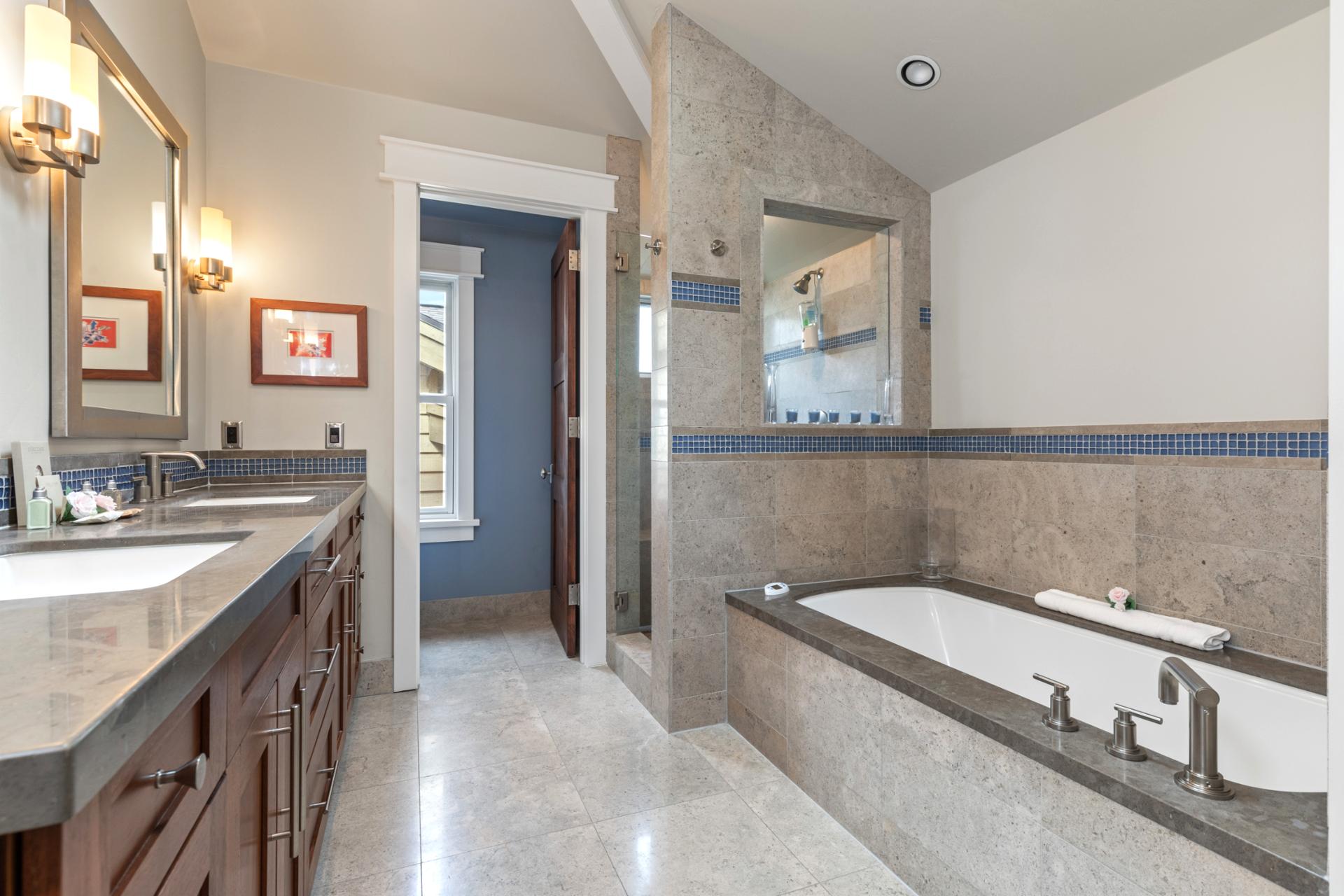 This spacious ensuite includes dual vanities, soaking tub, and a private water closet.