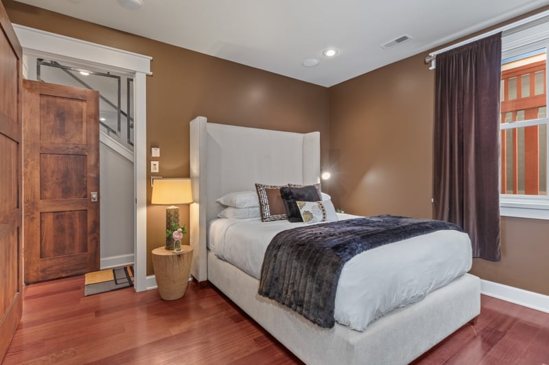 Bedroom 2 features a Queen bed, warm wood accents, and access to the shared bath.