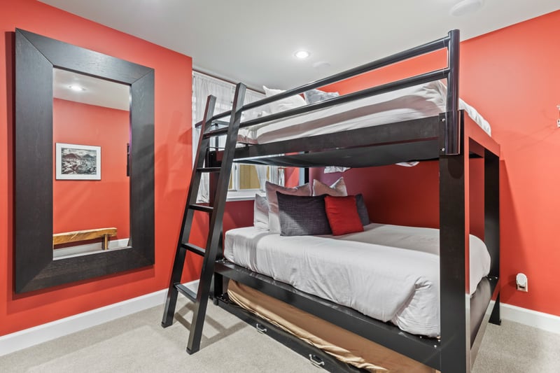 Bunk room with bold color and sleeping for up to five.
