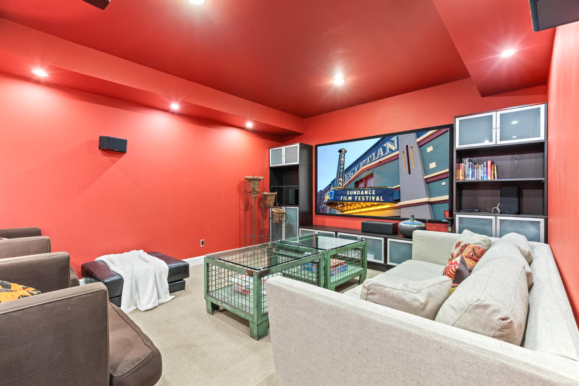 Your media room features theater lighting, Smart TV, and deep couches for binge-worthy nights.