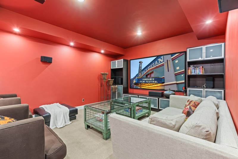 Your media room features theater lighting, Smart TV, and deep couches for binge-worthy nights.