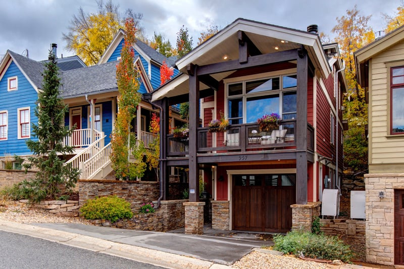 Exterior view shows classic mountain design with modern comfort and beautiful landscaping.