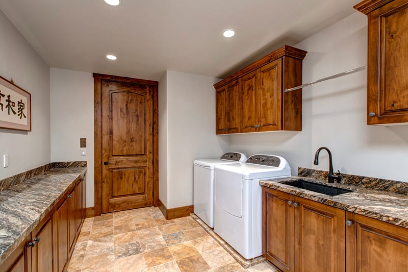 A full laundry room makes extended stays easy with washer, dryer, and storage space.