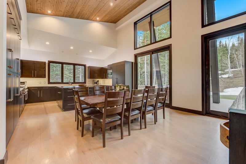Dining table for 10 sits beneath vaulted ceilings.