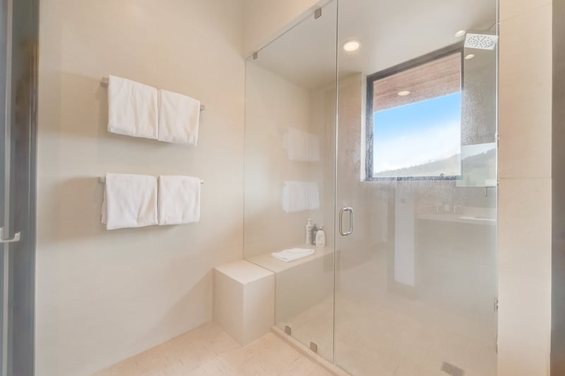 Ensuite with large walk-in shower and floating vanity creates a spa-like experience.