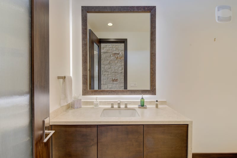Half bath off the main level offers modern finishes and easy access.