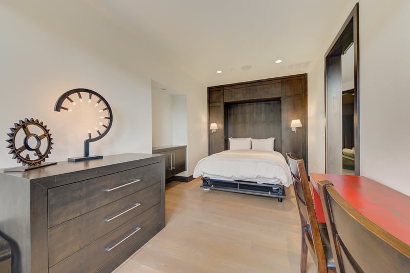 Guest bedroom with Queen bed, desk, and forest views offers peace and privacy.